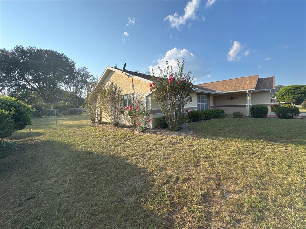 5440 Southwest 100th Loop Ocala, FL 34476 - Photo 3 of 37 a view of a house with a yard and a garage