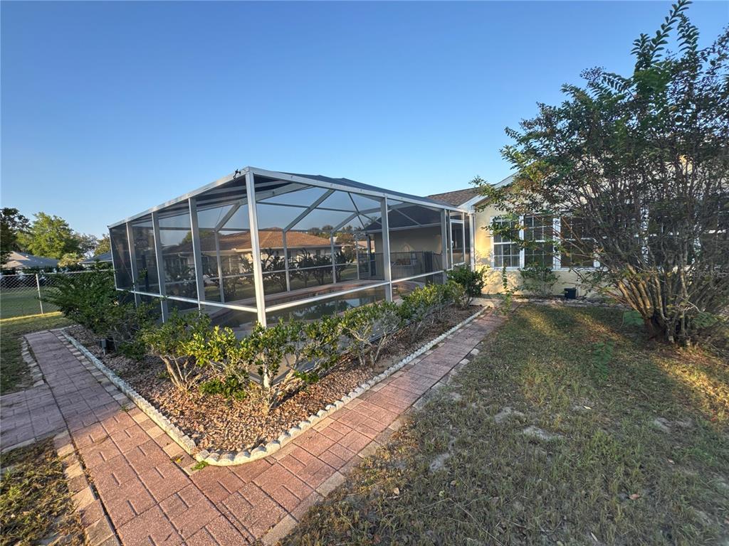 5440 Southwest 100th Loop Ocala, FL 34476 - Photo 31 of 37 a view of a house with a yard