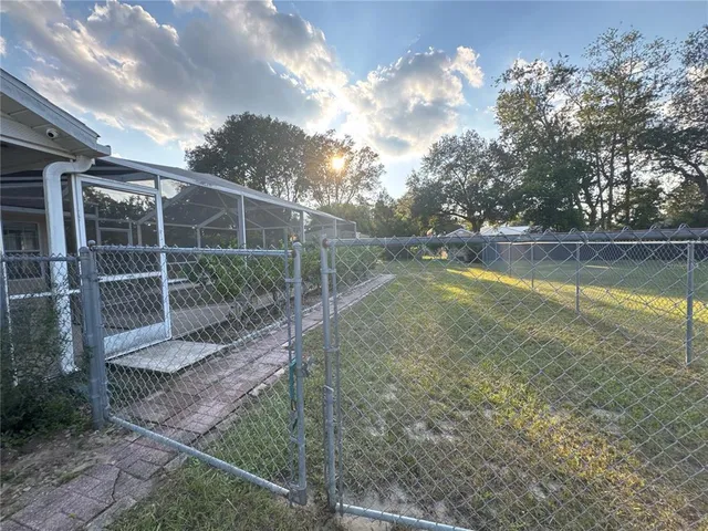 a view of a house with yard and sitting area