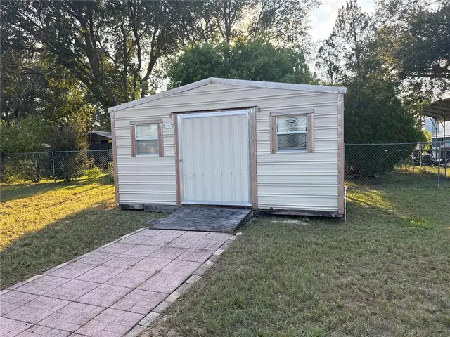 a view of a house with a backyard