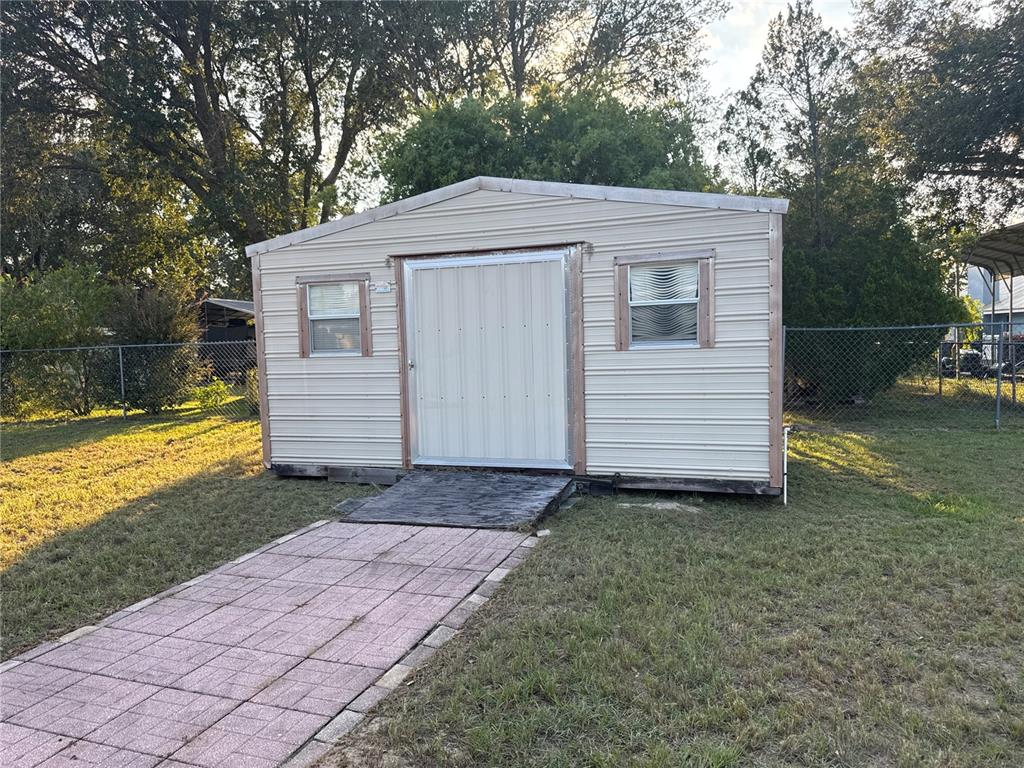 5440 Southwest 100th Loop Ocala, FL 34476 - Photo 33 of 37 a view of a house with a yard