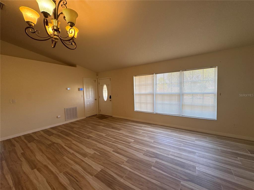 5440 Southwest 100th Loop Ocala, FL 34476 - Photo 4 of 37 a view of room with window and wooden floor