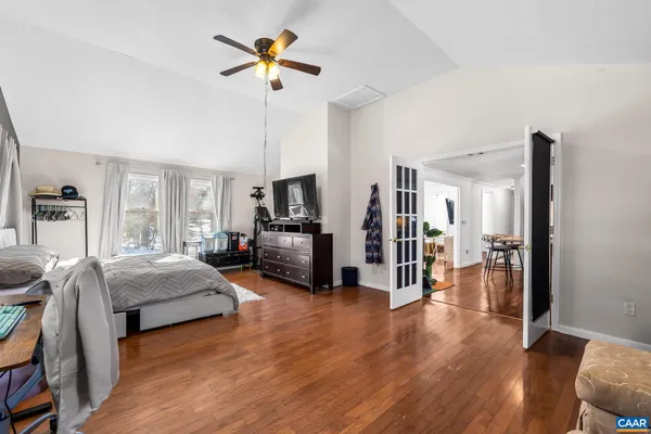 a living room with furniture and a wooden floor