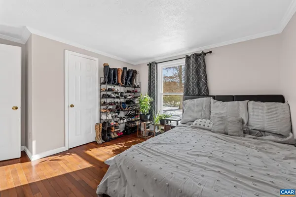 a bedroom with a bed and a large mirror