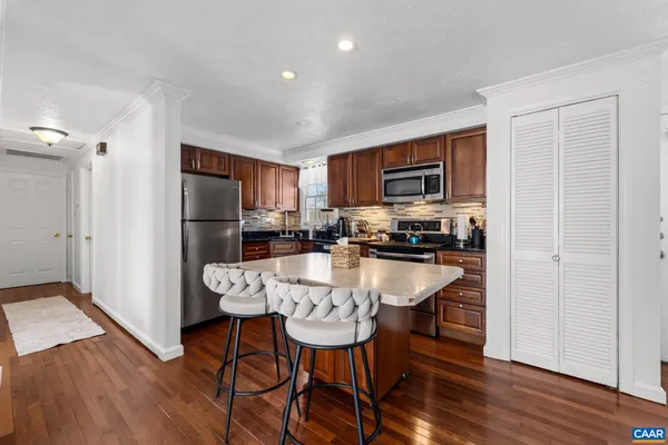 a large kitchen with a table and chairs