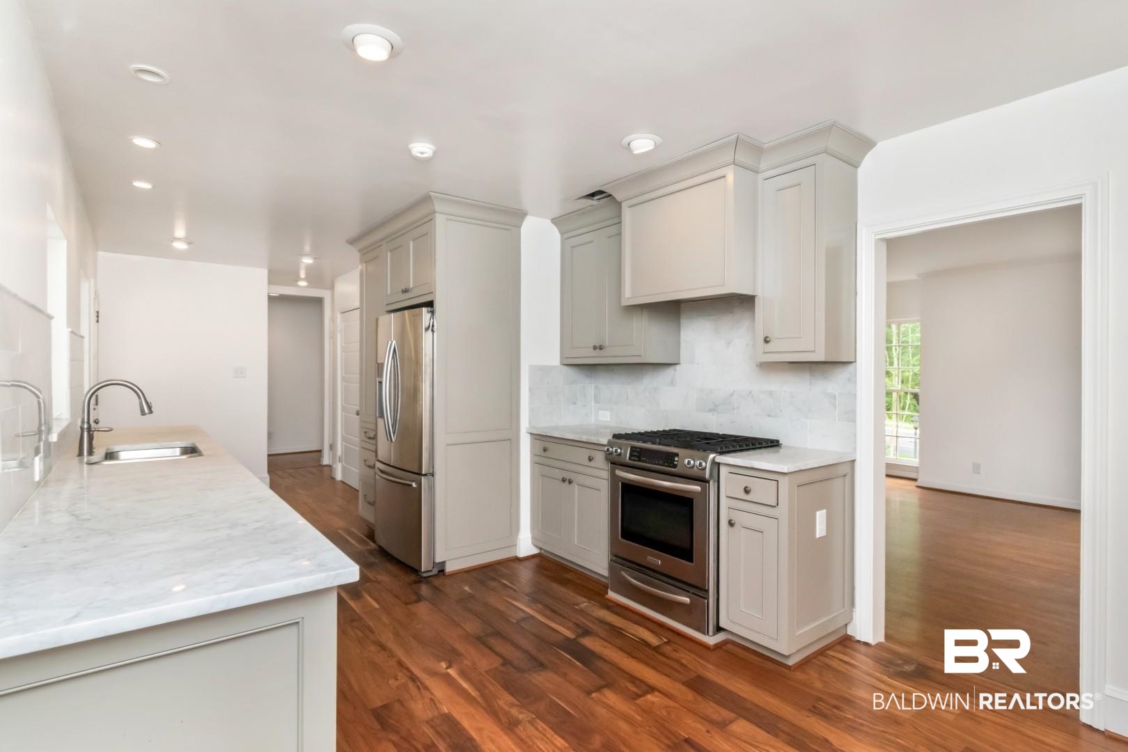 4 Turnout Lane Mobile, AL 36608 - Photo 7 of 53 Kitchen with stainless steel appliances, dark wood-style flooring, and light stone countertops