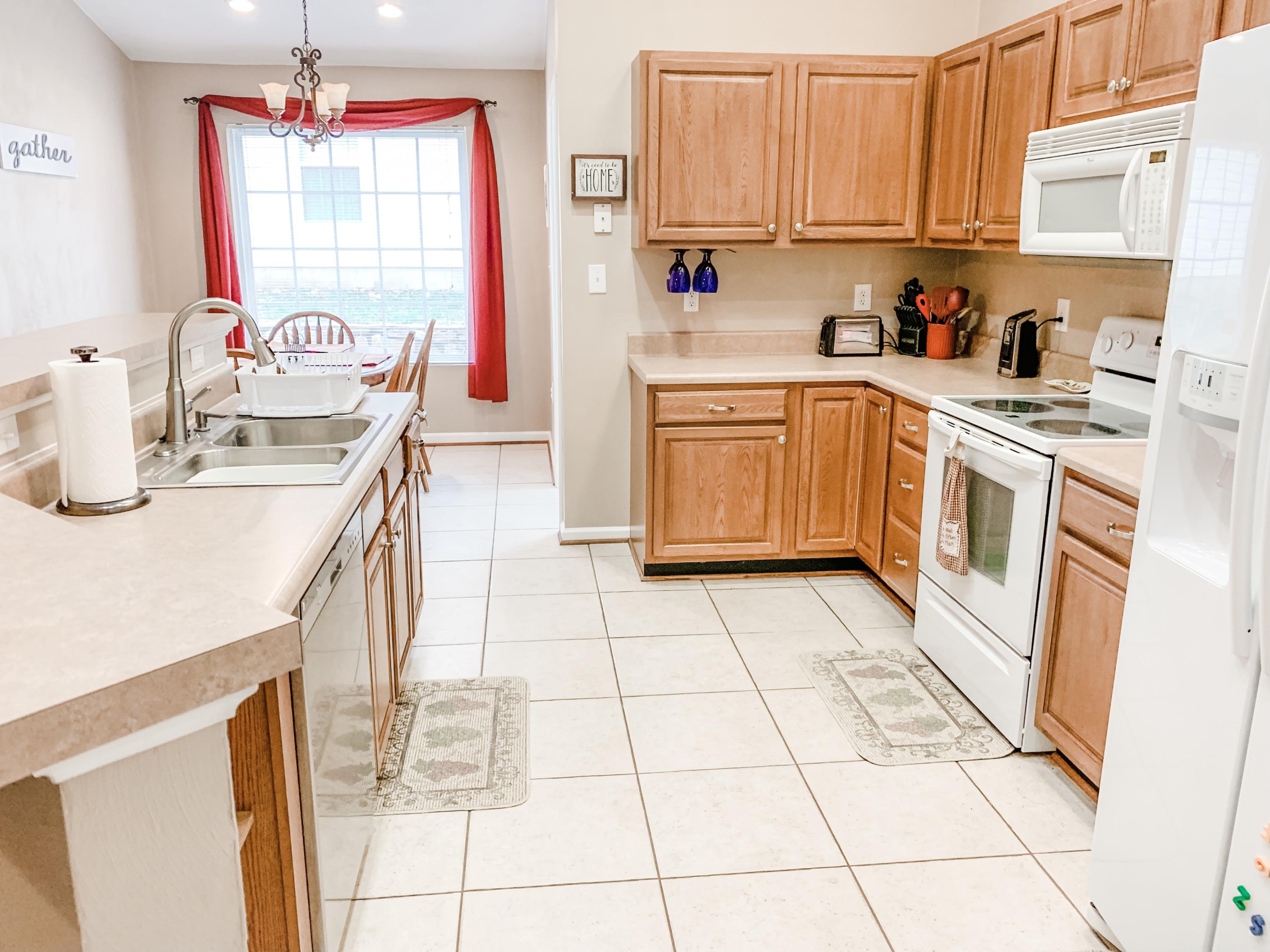 4242 Daugherty Road Salem, VA 24153 - Photo 15 of 40 a kitchen with a sink a stove a microwave and cabinets