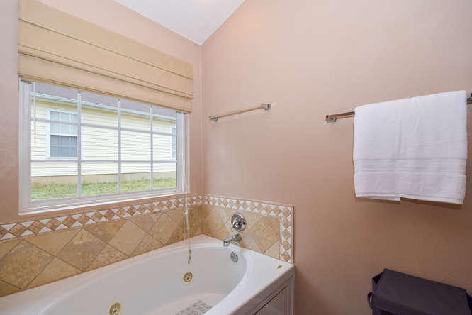 4242 Daugherty Road Salem, VA 24153 - Photo 21 of 40 a bathroom with a bathtub and next to a window