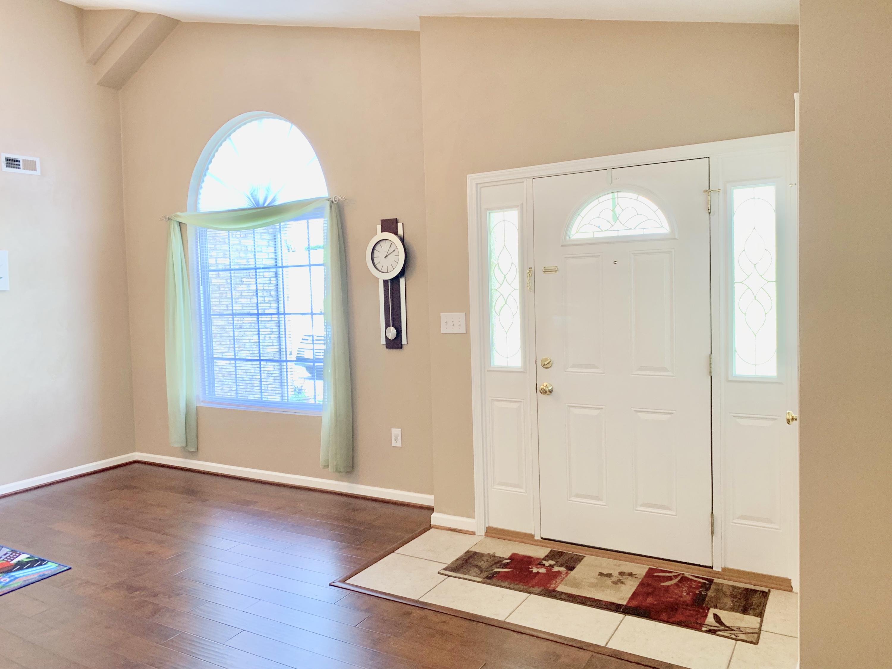 4242 Daugherty Road Salem, VA 24153 - Photo 6 of 40 an empty room with wooden floor mirror and windows