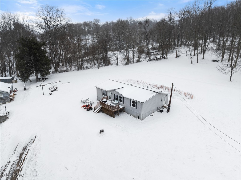 72117 Barton Road Bridgeport, OH 43912 - Photo 2 of 42 Snowy aerial view with view of wooded area