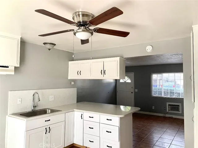 a kitchen with a sink a stove and cabinets