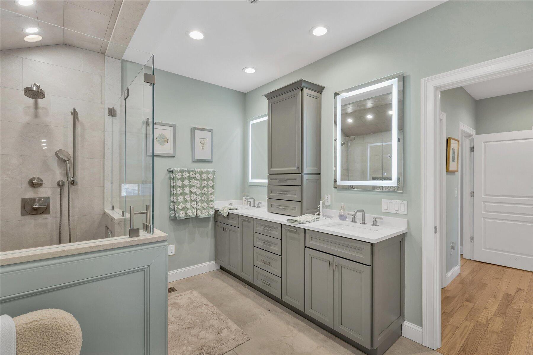 77 The Heights Mashpee, MA 02649 - Photo 23 of 52 a spacious bathroom with a double vanity sink a large mirror and shower
