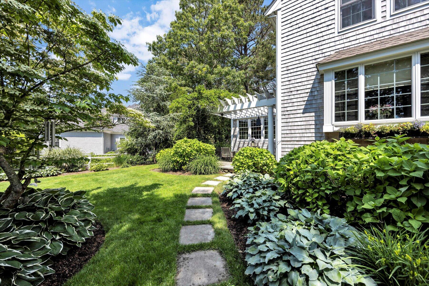 77 The Heights Mashpee, MA 02649 - Photo 40 of 52 a view of a house with a yard and potted plants