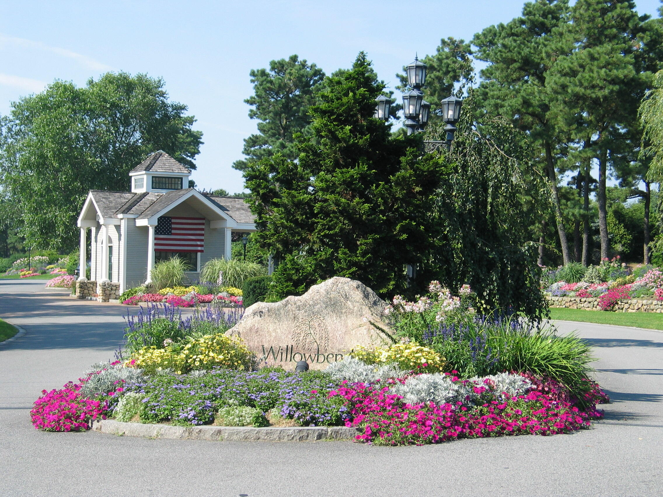 77 The Heights Mashpee, MA 02649 - Photo 42 of 52 a front view of a house with a yard and garage
