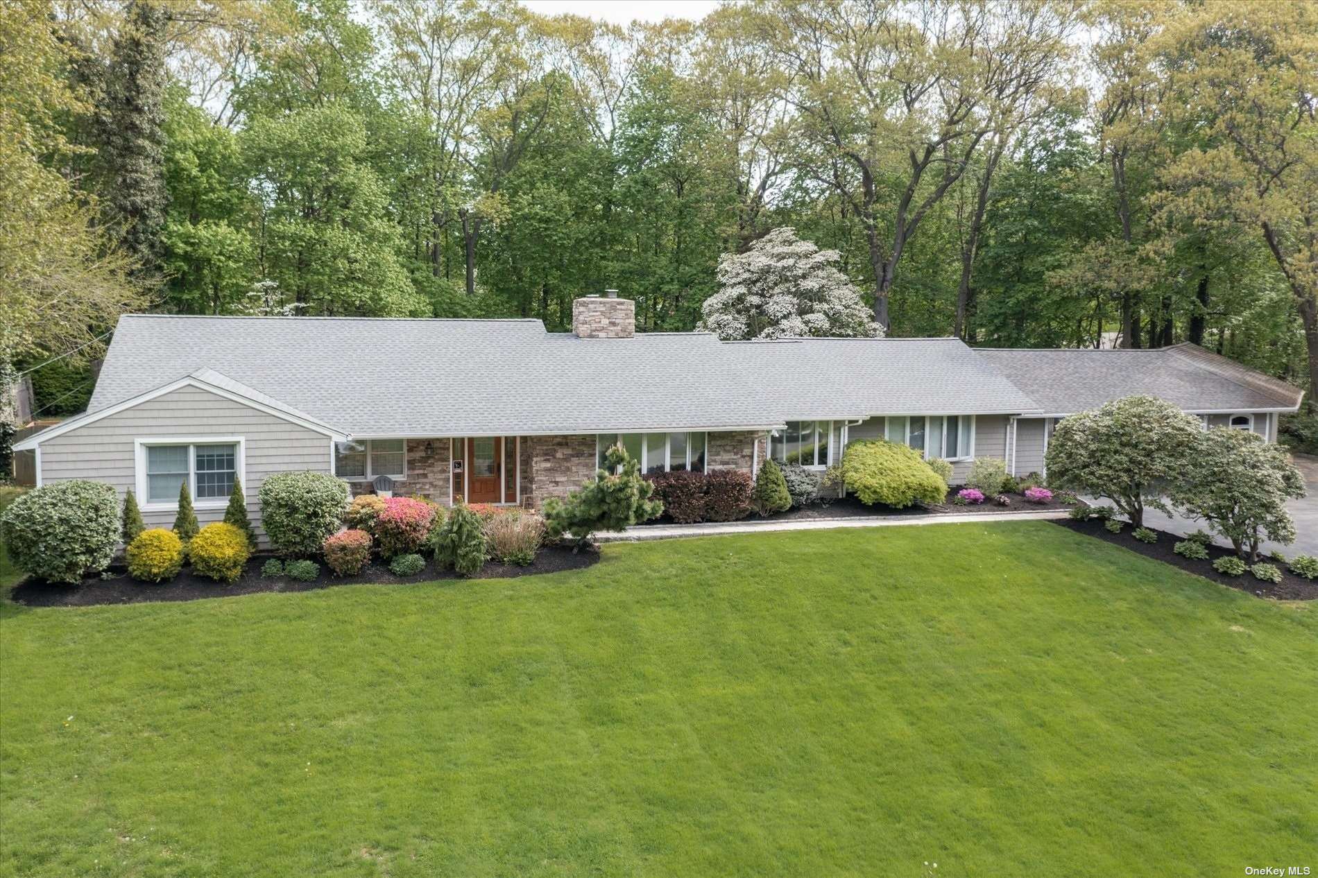 15 Harmony Road Huntington, NY 11743 - Photo 1 of 1 a aerial view of a house next to a big yard and large trees