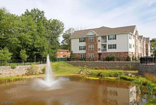 a view of a house with pool and sitting area