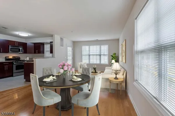 a view of a dining room with furniture and wooden floor