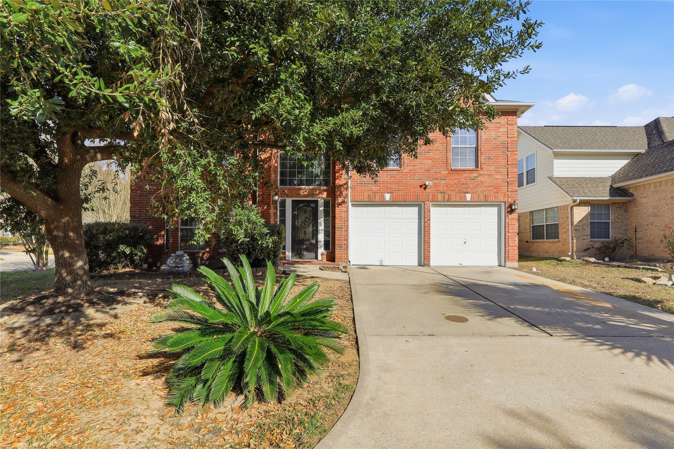 a view of a house with a tree in front
