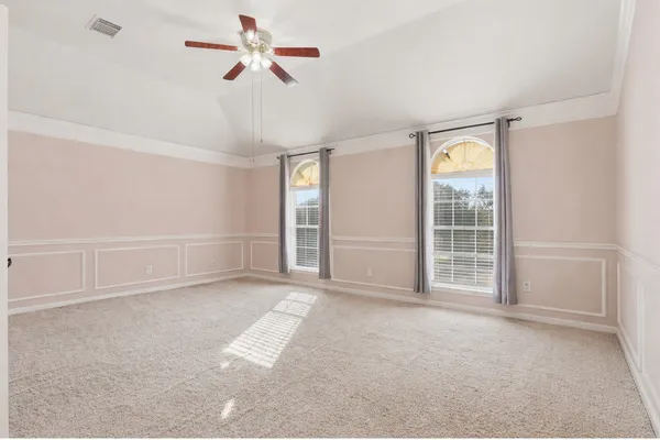 a view of empty room with ceiling fan