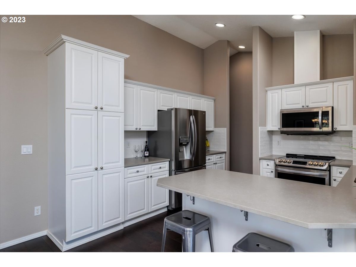 15855 Southwest Colyer Way Portland, OR 97224 - Photo 14 of 37 a kitchen with a refrigerator and a stove top oven