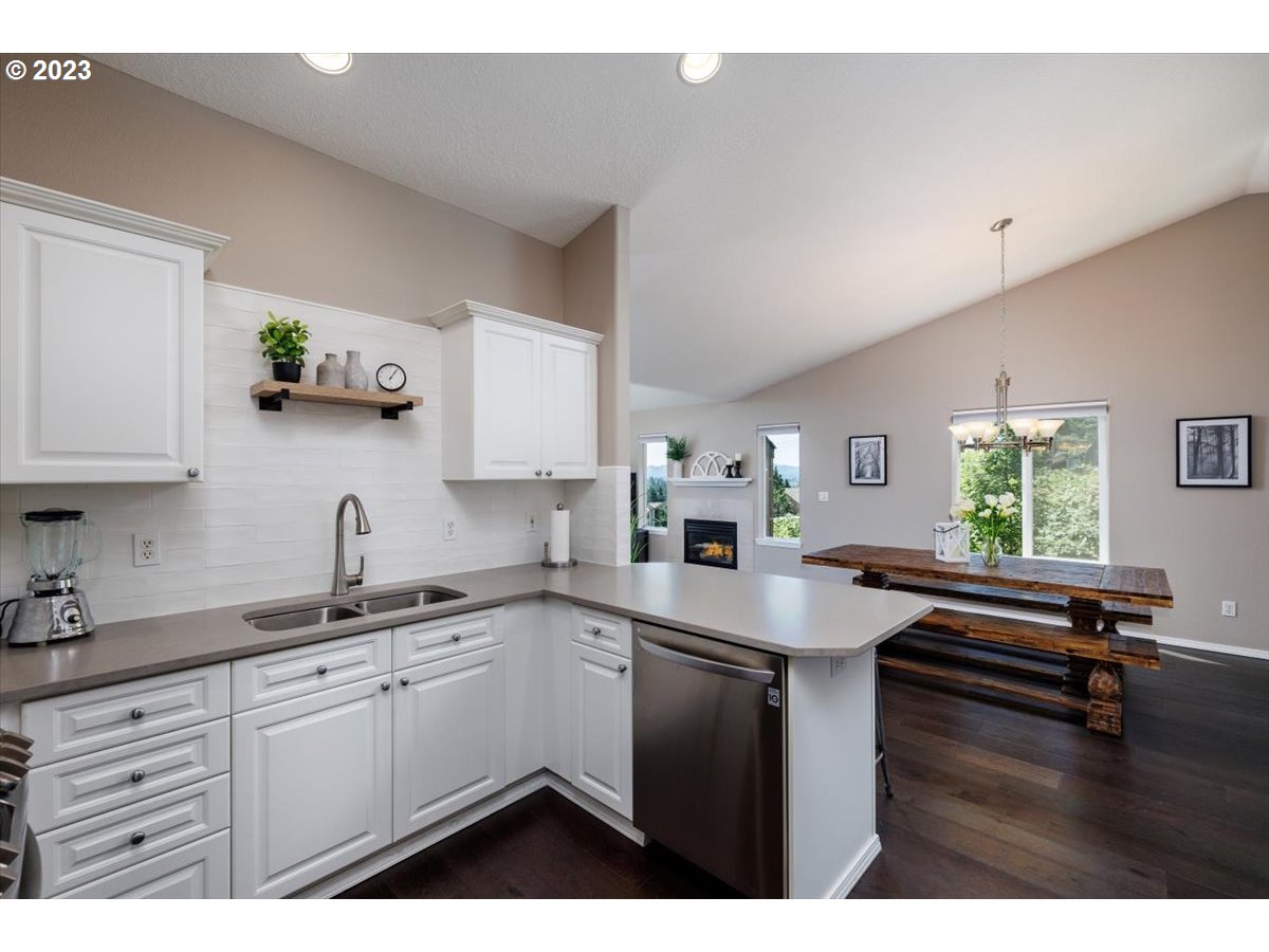 15855 Southwest Colyer Way Portland, OR 97224 - Photo 16 of 37 a kitchen with sink cabinets and wooden floor