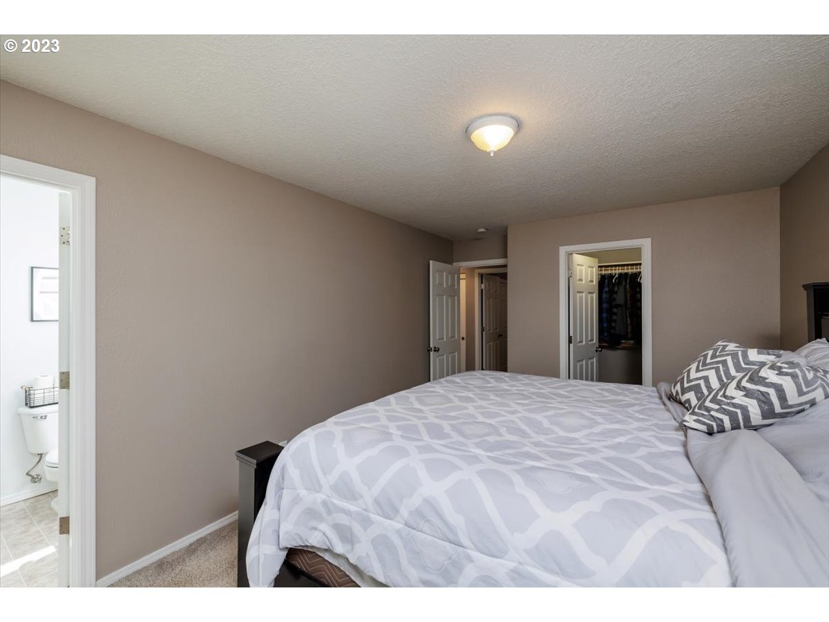 15855 Southwest Colyer Way Portland, OR 97224 - Photo 19 of 37 a bedroom with a bed and a night stand