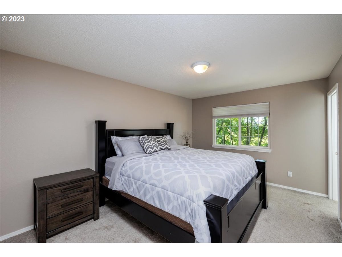 15855 Southwest Colyer Way Portland, OR 97224 - Photo 20 of 37 a bedroom with a bed table and a window