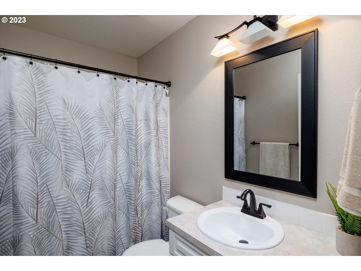 15855 Southwest Colyer Way Portland, OR 97224 - Photo 27 of 37 a bathroom with a sink and a mirror