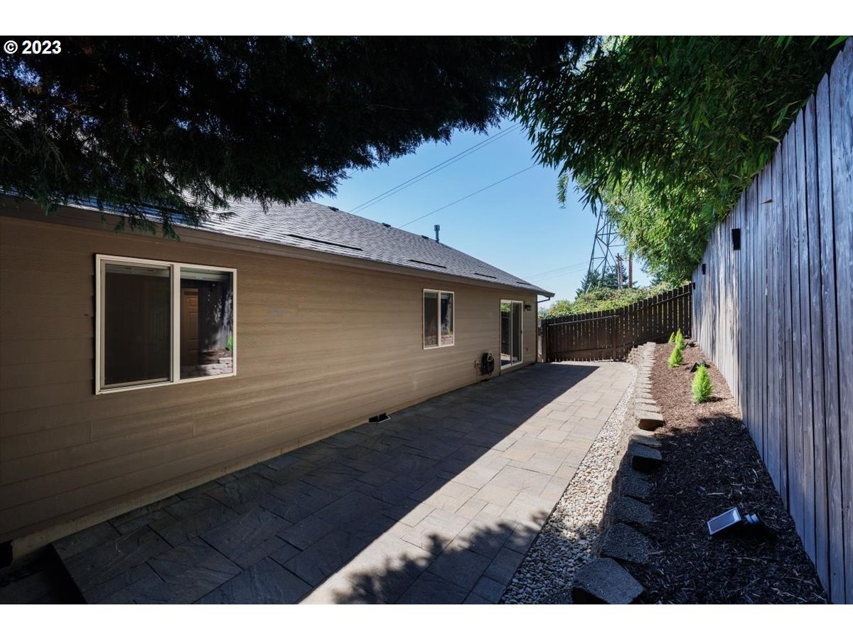 15855 Southwest Colyer Way Portland, OR 97224 - Photo 33 of 37 a balcony with wooden floor and yard in the back