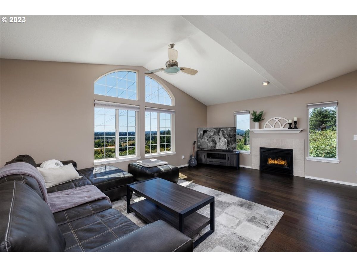 15855 Southwest Colyer Way Portland, OR 97224 - Photo 7 of 37 a living room with furniture a fireplace and a large window