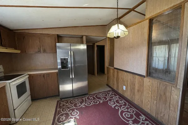 a view of a livingroom with furniture and an entryway