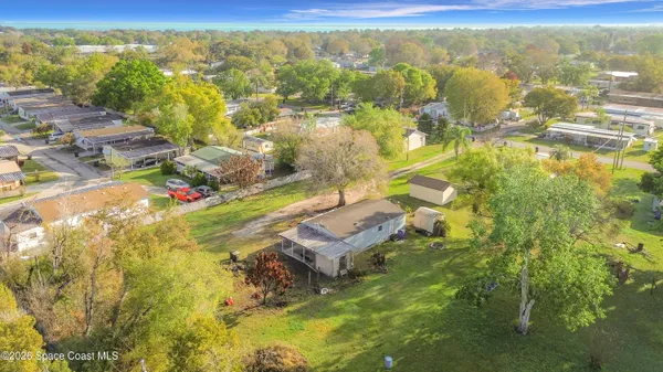 an aerial view of residential houses with city view