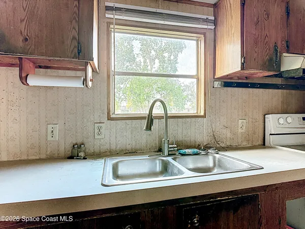 a kitchen with a stove a sink and a refrigerator