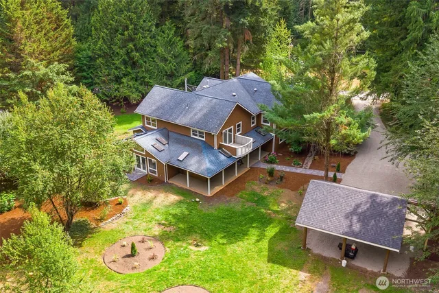 an aerial view of a house with garden space and a swimming pool