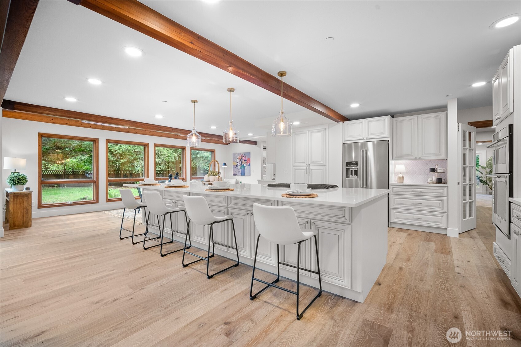 5656 Doran Road Acme, WA 98220 - Photo 4 of 39 a kitchen with stainless steel appliances kitchen island granite countertop a table chairs in it and wooden floors