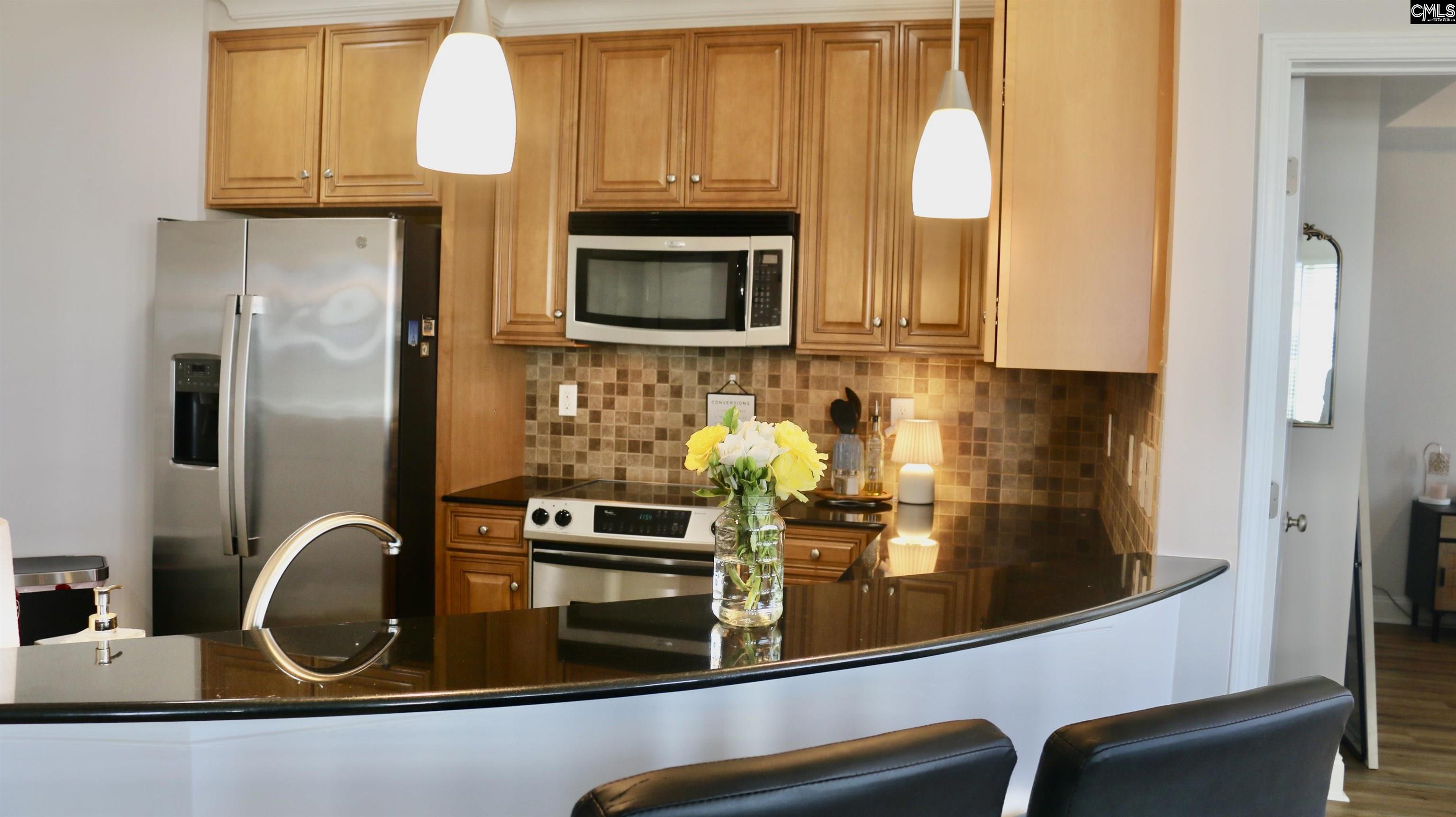 601 Main Street, Unit 323 Columbia, SC 29201 - Photo 15 of 68 a kitchen with stainless steel appliances granite countertop a refrigerator and a stove top oven