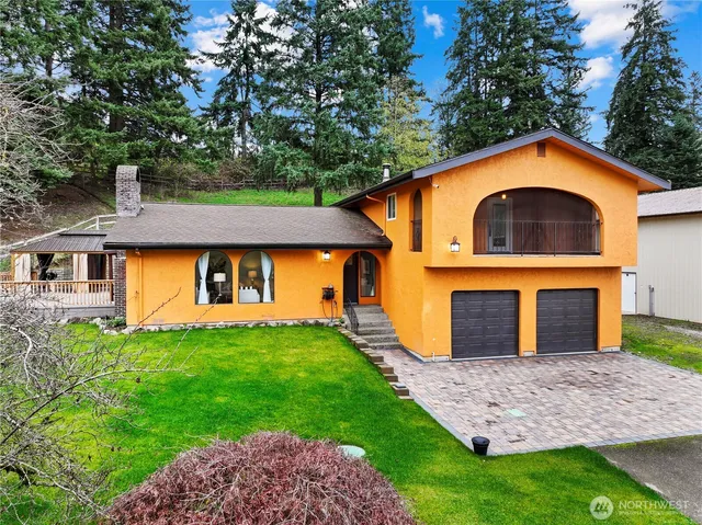 a front view of a house with a yard and garage