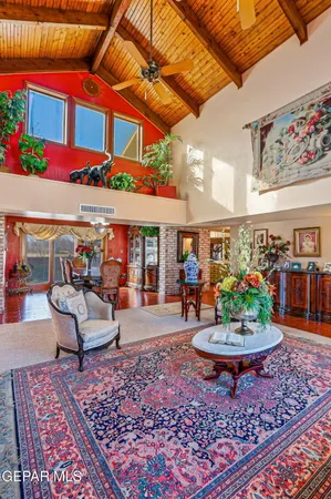 a living room with furniture a table and a fireplace