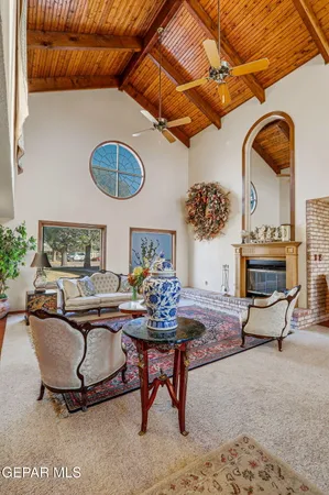 a view of a dining room and livingroom with furniture wooden floor a chandelier