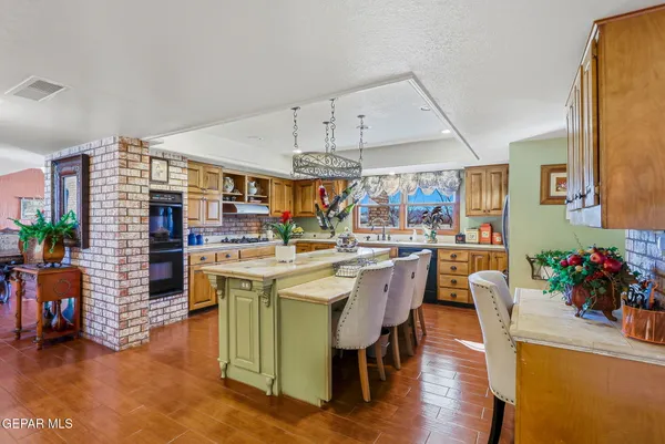 a kitchen with stainless steel appliances a sink cabinets and wooden floor