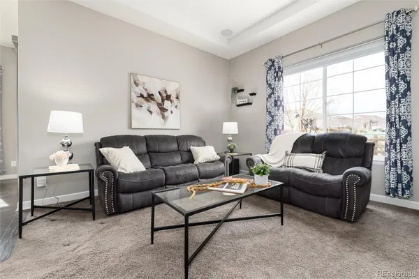 a living room with furniture and a large window