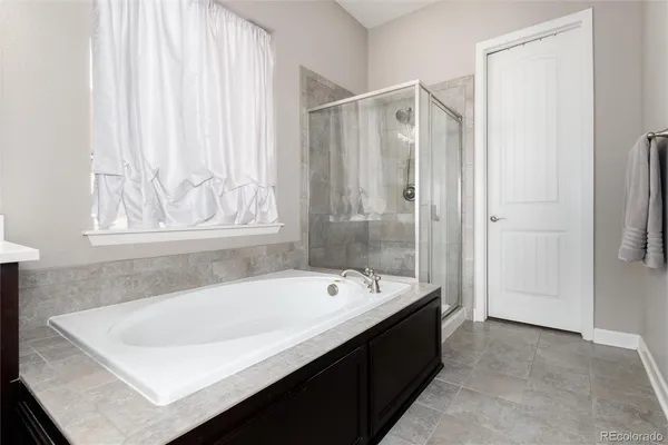 a bathroom with a bathtub and shower