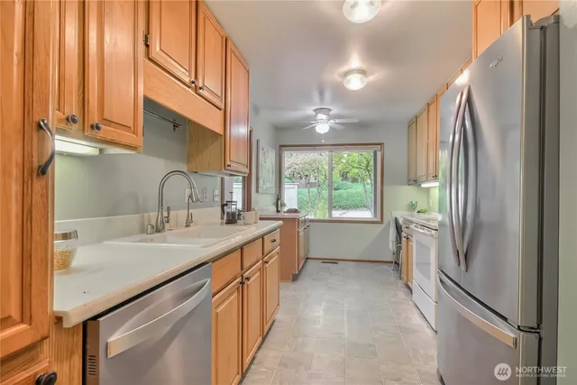 a kitchen with sink a refrigerator and window