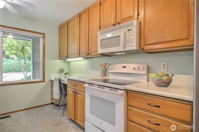 a kitchen with stainless steel appliances granite countertop a sink and cabinets