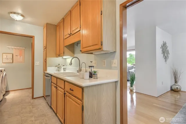 a kitchen with a sink cabinets and a window