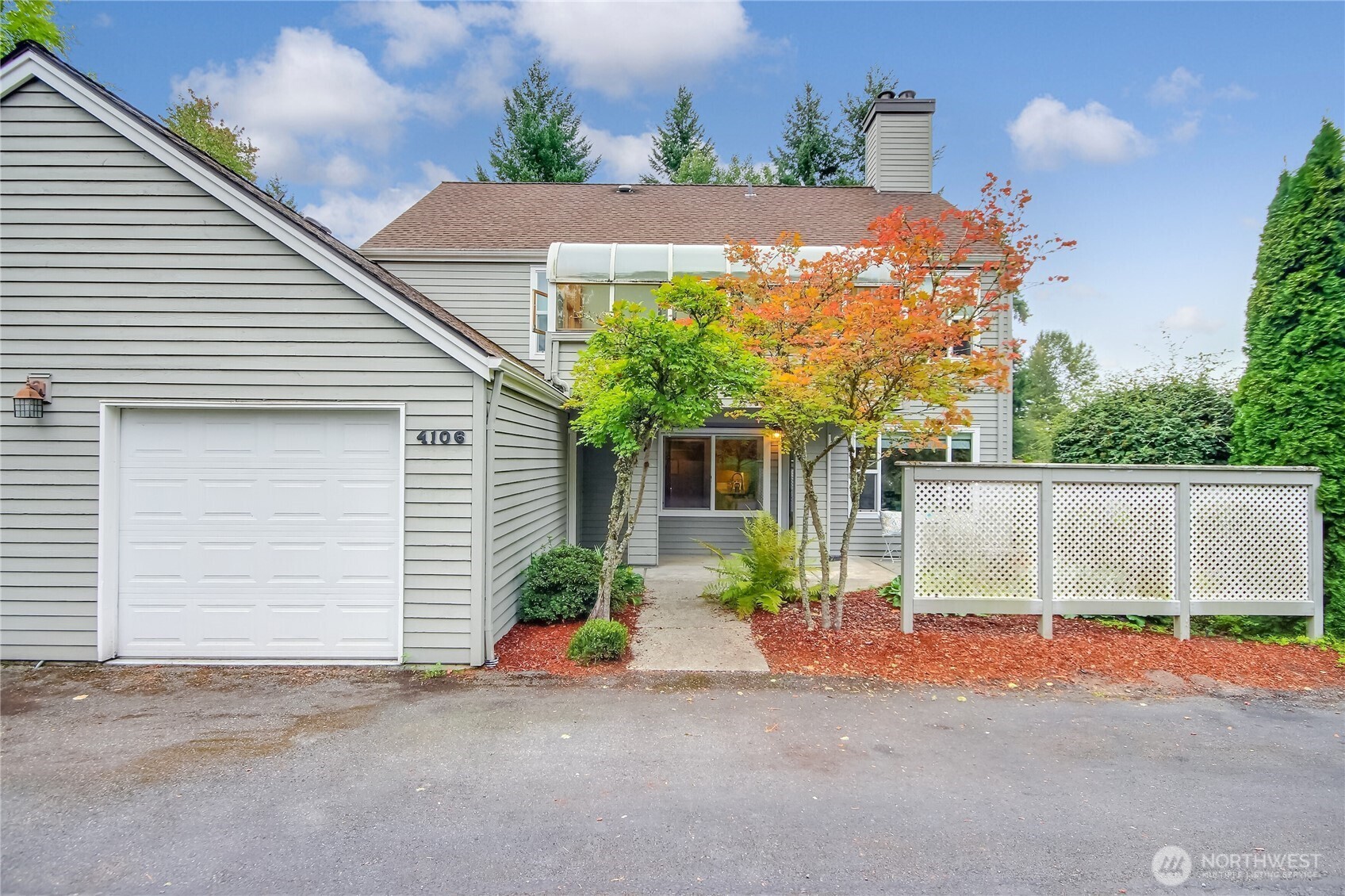 4106 221st Place Southeast, Unit 1072 Issaquah, WA 98029 - Photo 2 of 40 a front view of a house with a yard and garage
