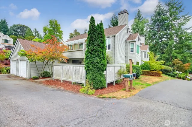 front view of house with a yard and potted plants