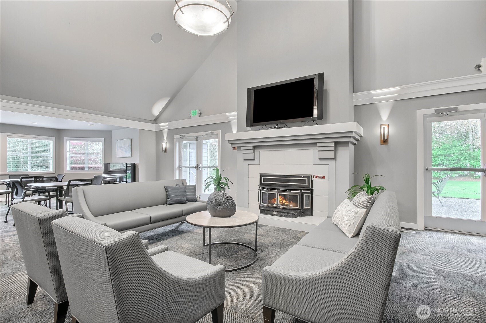 4106 221st Place Southeast, Unit 1072 Issaquah, WA 98029 - Photo 30 of 40 a living room with furniture a fireplace and a flat screen tv