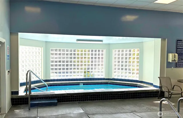 a bedroom with a bed and windows