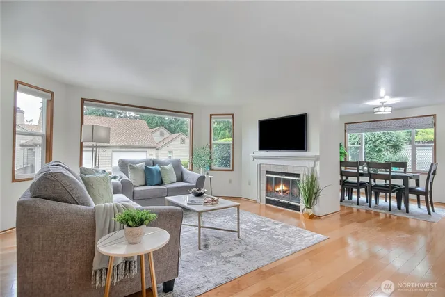 a living room with furniture a flat screen tv and a large window